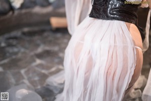 A woman in a black corset and a white dress.