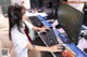 A woman sitting at a desk using a computer.