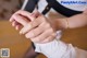 A close up of a person's hands with a ring on their finger.