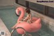 A woman sitting on an inflatable flamingo in a swimming pool.