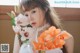 A woman in a white dress holding a bunch of flowers.